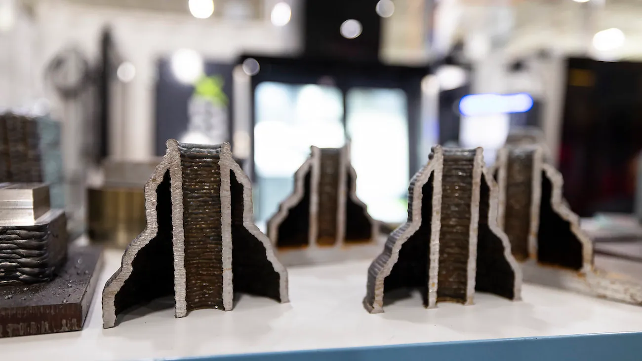 Several conical objects with hollowed internal cylinders sit on a surface; they have been cut in half to reveal their internal structure. 