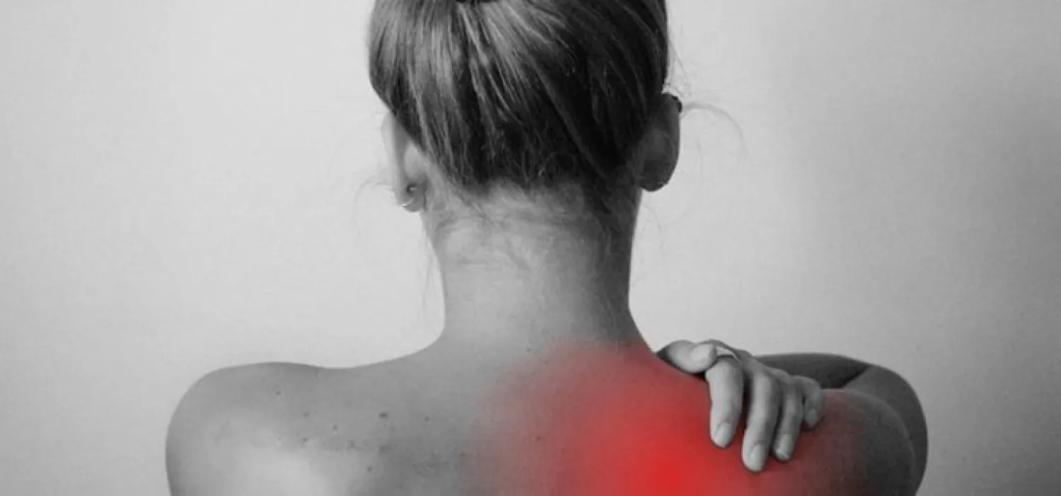 Photo of individual’s back with red highlights indicating pain on their right shoulder.