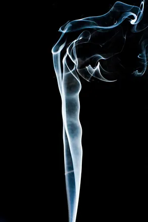 Figure is a photo of smoke that rises smoothly at the bottom and forms swirls and eddies at the top.