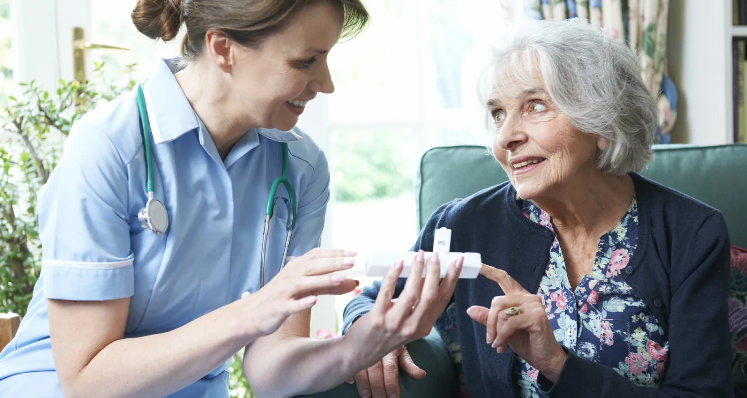 Photo of healthcare worked showing individual pill box.