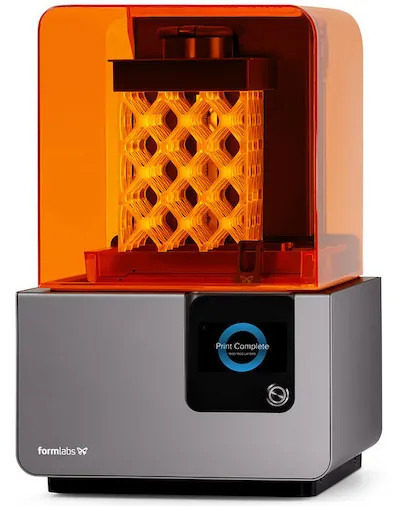 A 3D printer is shown printing a rectangular object that is structured in a lattice, with diamond-shaped cutouts throughout the object. 