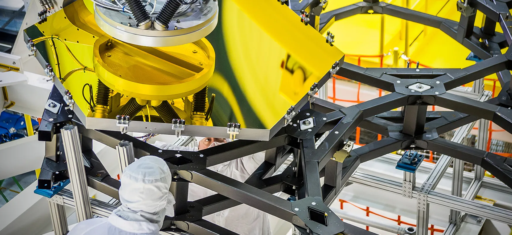An engineer works on a robotic arm.