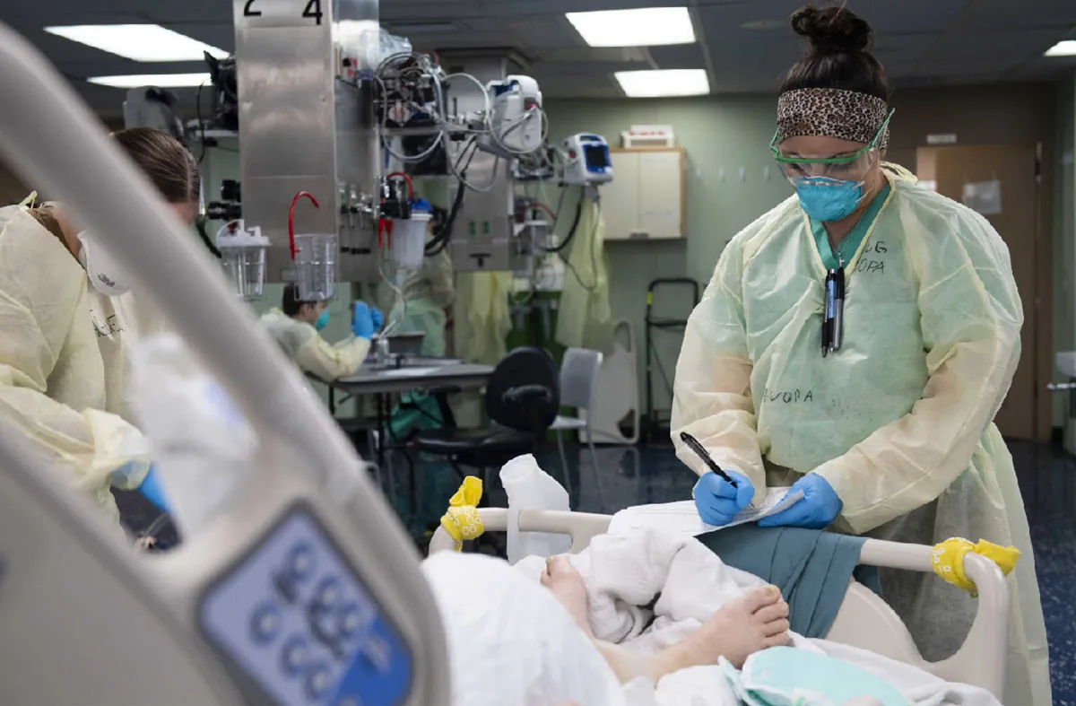 A color photograph shows healthcare professionals in a hospital setting wearing safety masks and other coverings.