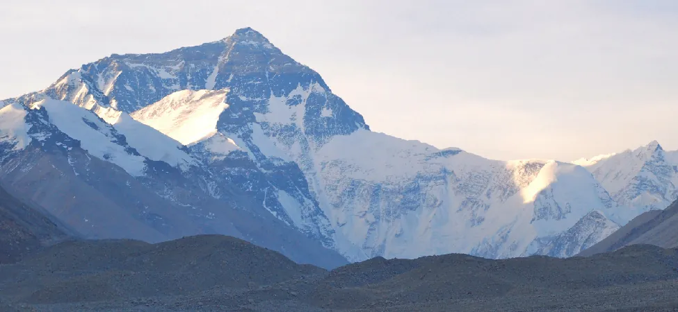 Photo shows a snow-covered mountain range.