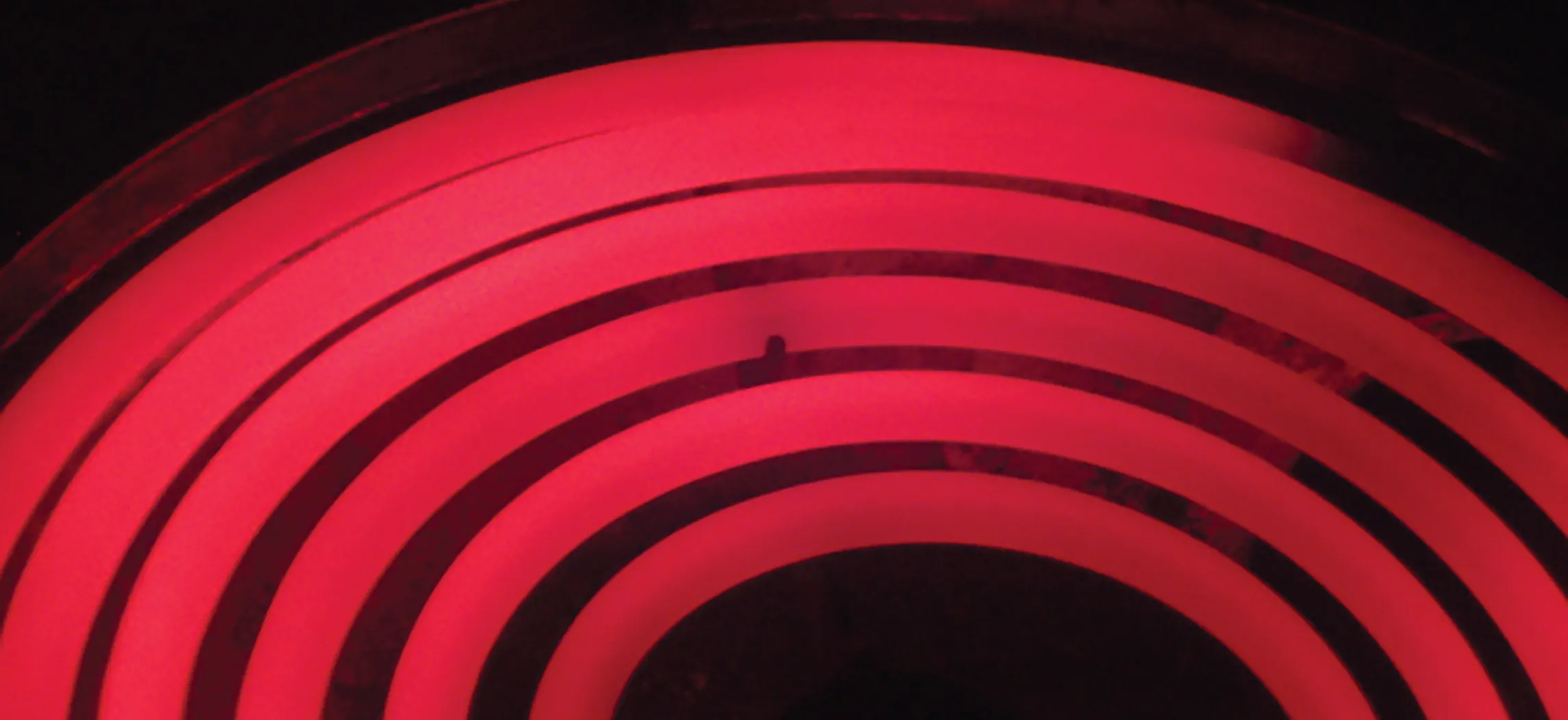 This photo shows a red hot electric stove top.