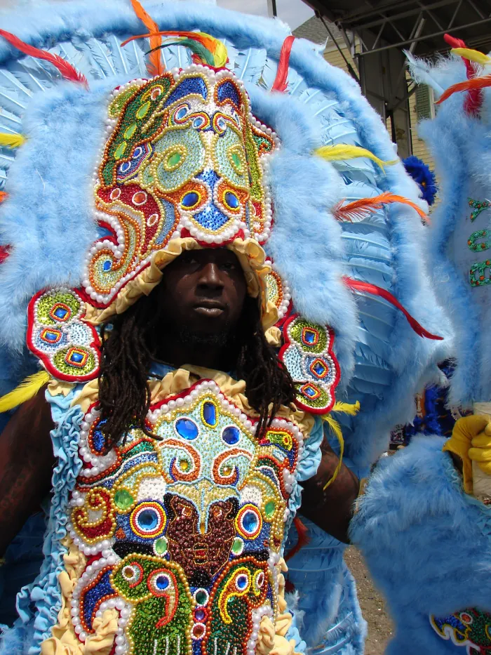 An individual dressed in a colorful traditional costume, celebrating Traditional Mardi Gras Indians in Louisiana.