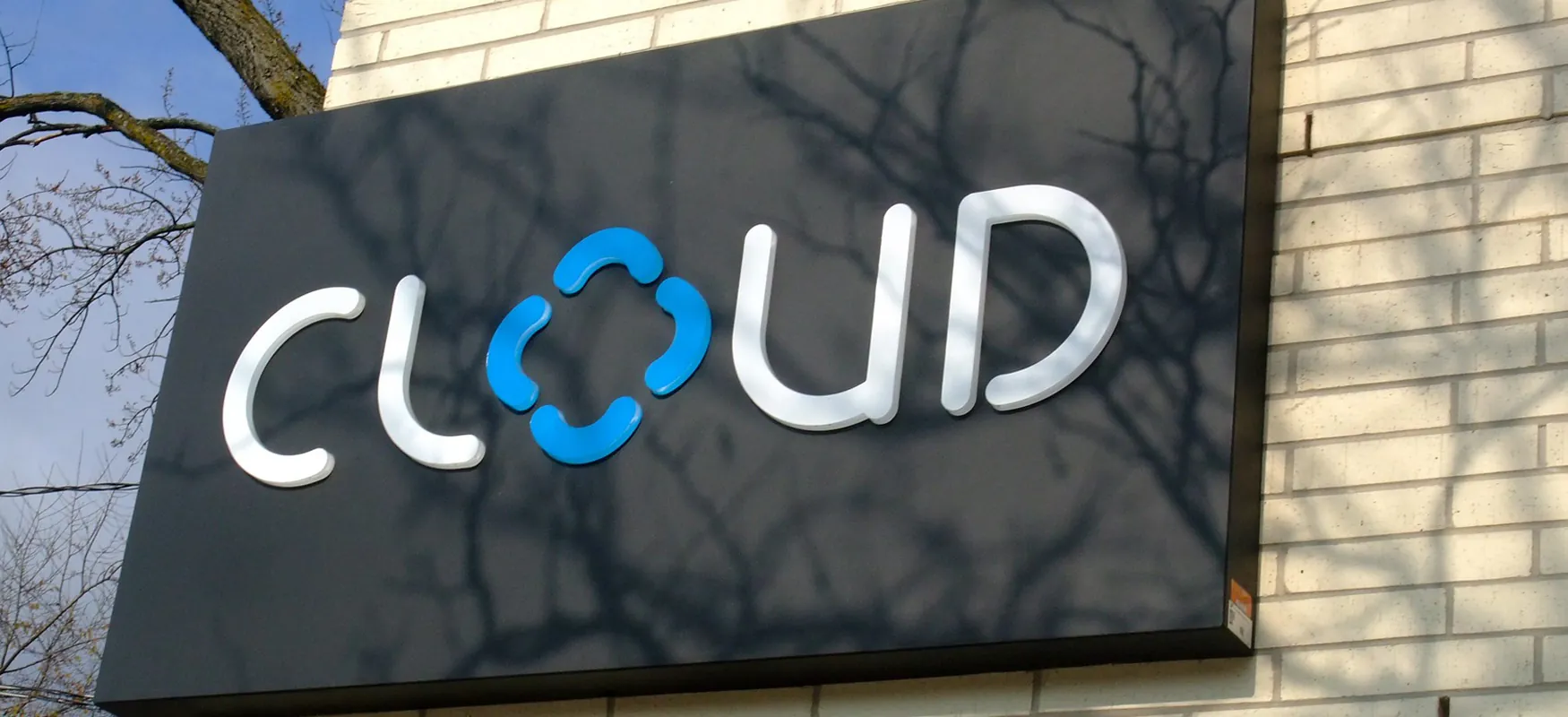 A photograph of a building with a cloud sign on it.