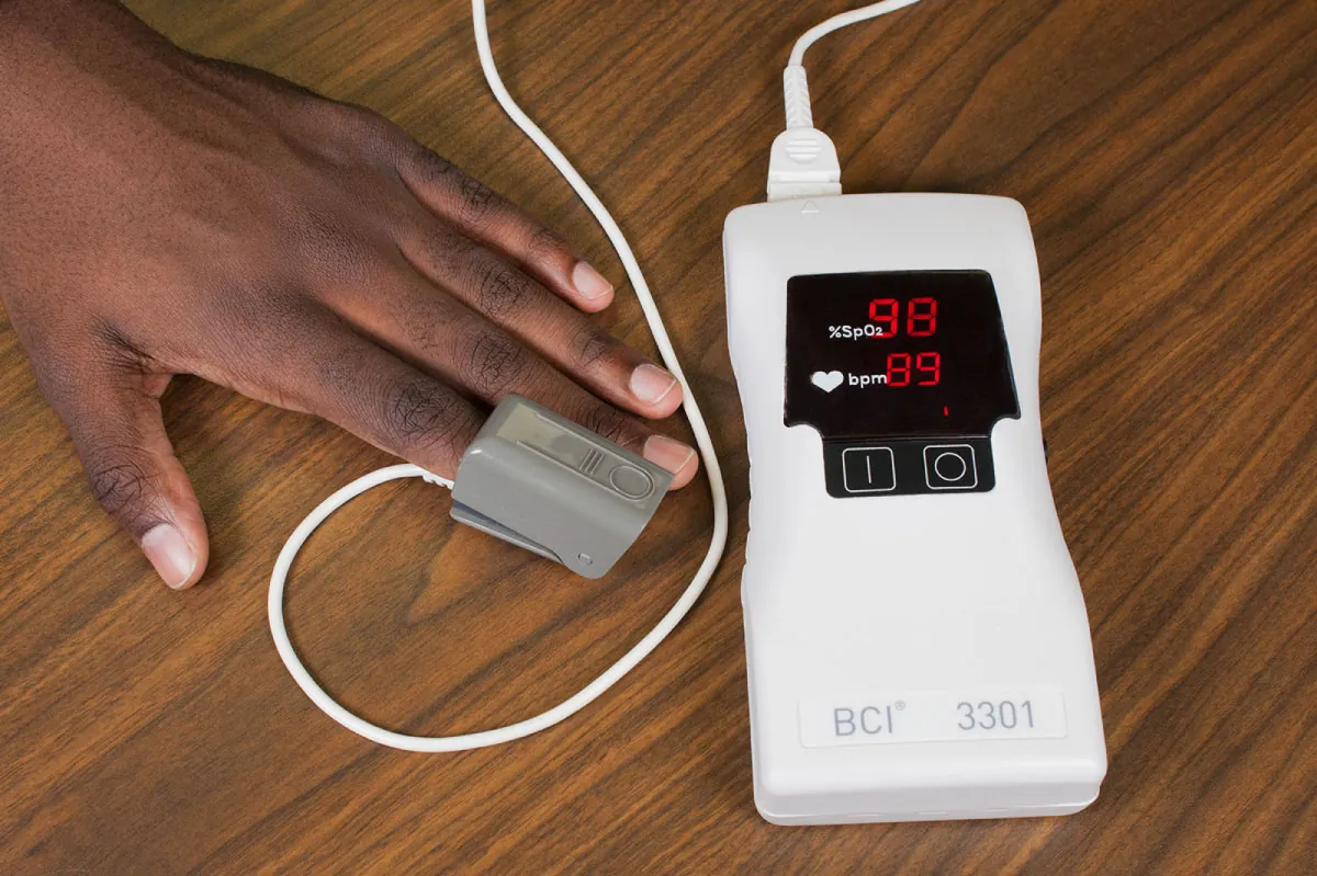 Patient’s hand with pulse oximeter attached to finger