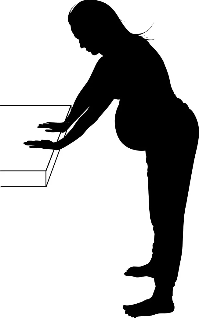 A silhouette of a pregnant woman slightly bent forward at the waist, holding a table in front of her