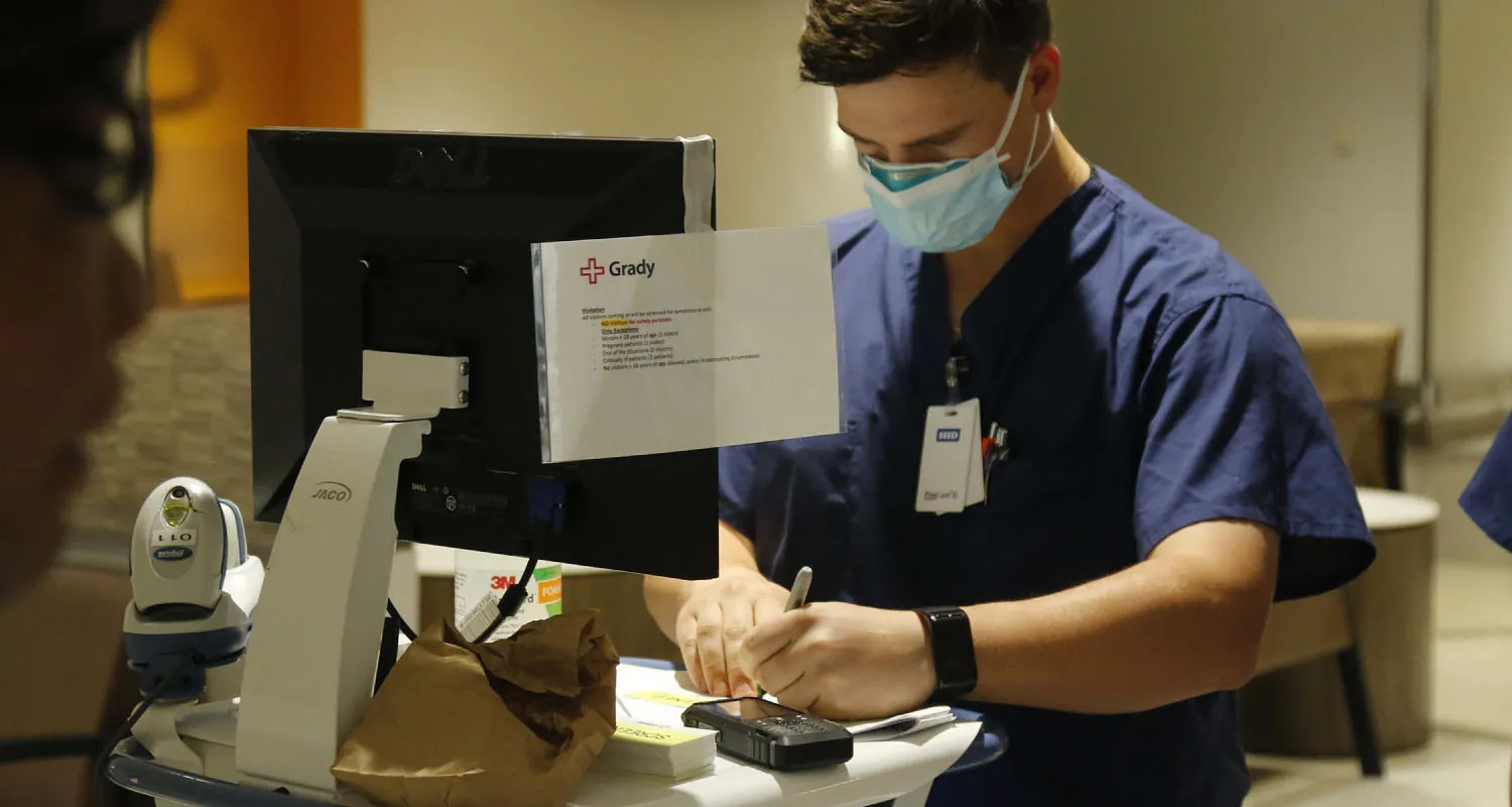 Healthcare provider filling out form.