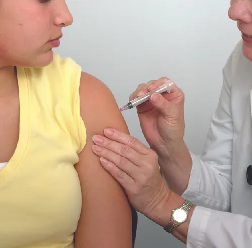 Photo of person getting a shot.