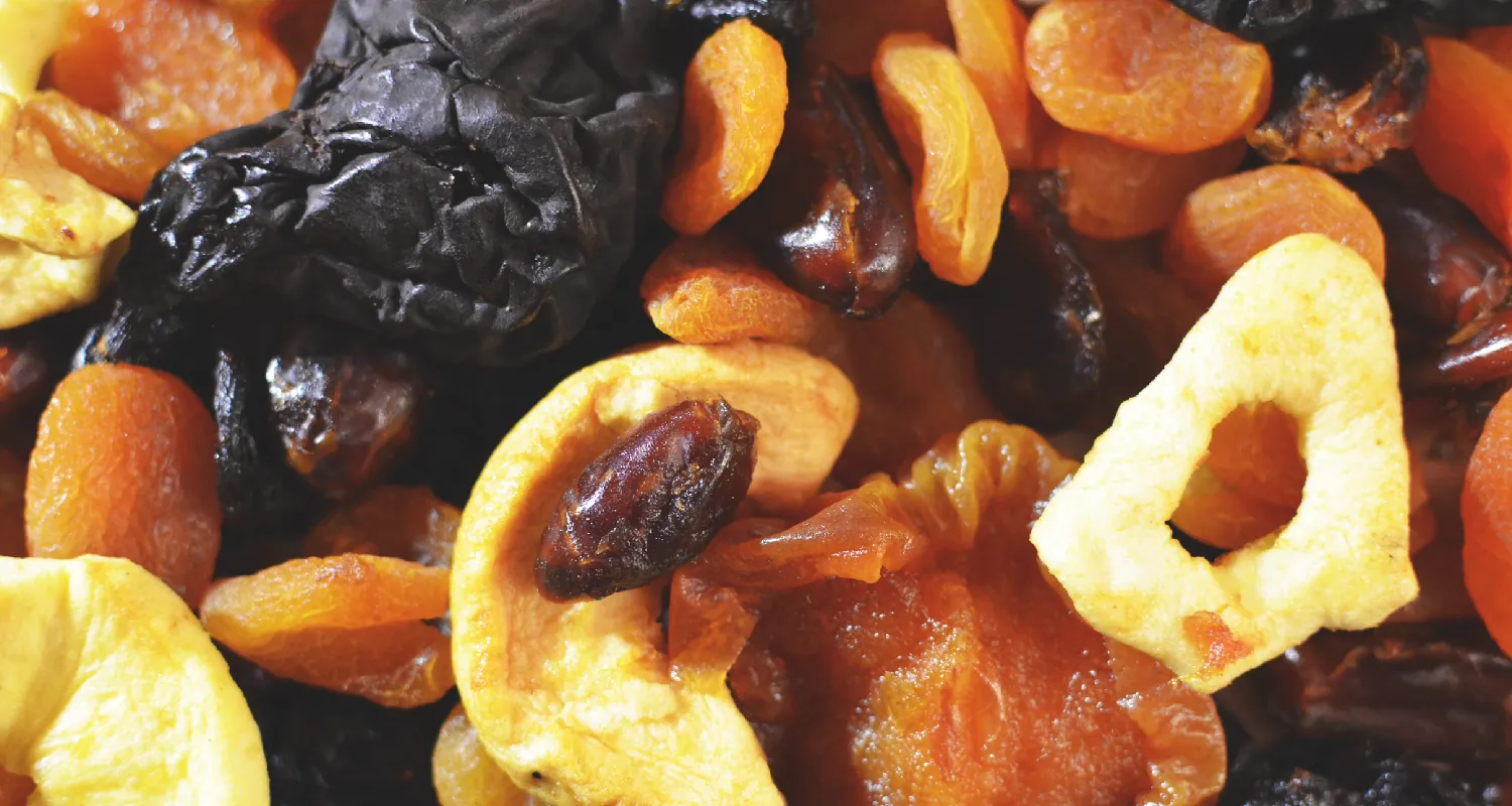 A close-up of a variety of nuts and dried fruits.
