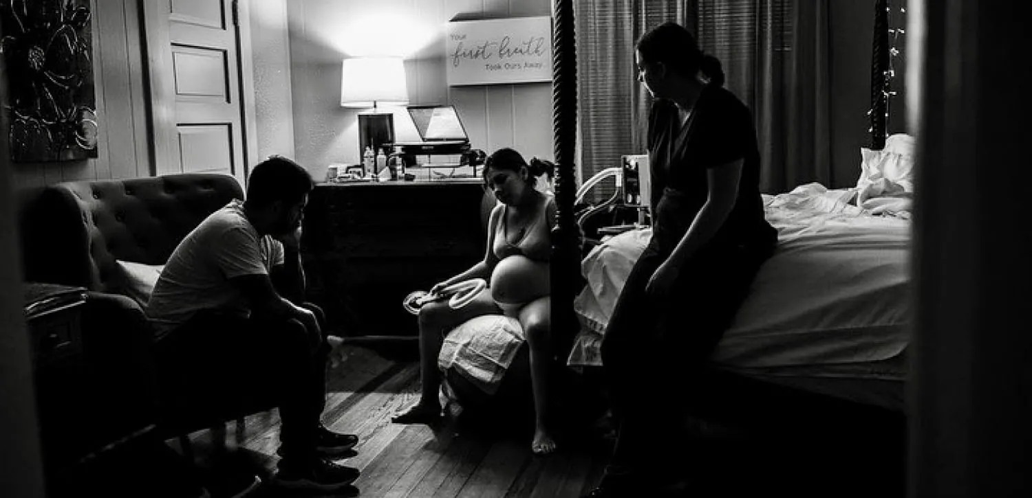 Laboring person sitting on a birthing ball.