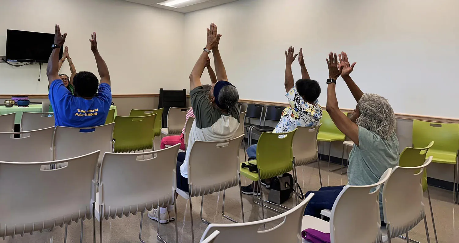 People in chairs practicing yoga