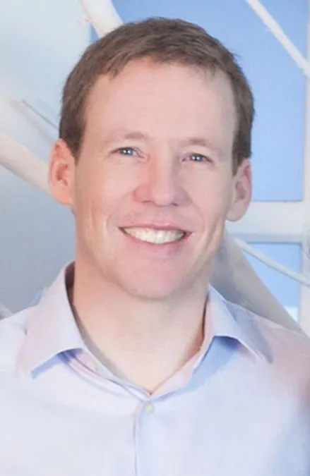 A photograph of a smiling adult man.