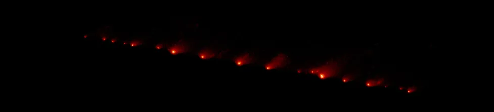 Image of Comet Shoemaker–Levy 9 taken by the Hubble Space Telescope. During a close approach to Jupiter before the collision, the original comet broke-up into many pieces. This photograph shows a long chain of about 20 of these cometary fragments, the larger ones having diffuse tails pointing toward the upper right of the image.