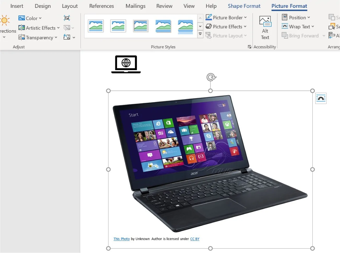 A picture of an open laptop image is inserted into a document. The bottom left corner of the picture reads: This Photo by Unknown Author is licensed under CC BY.