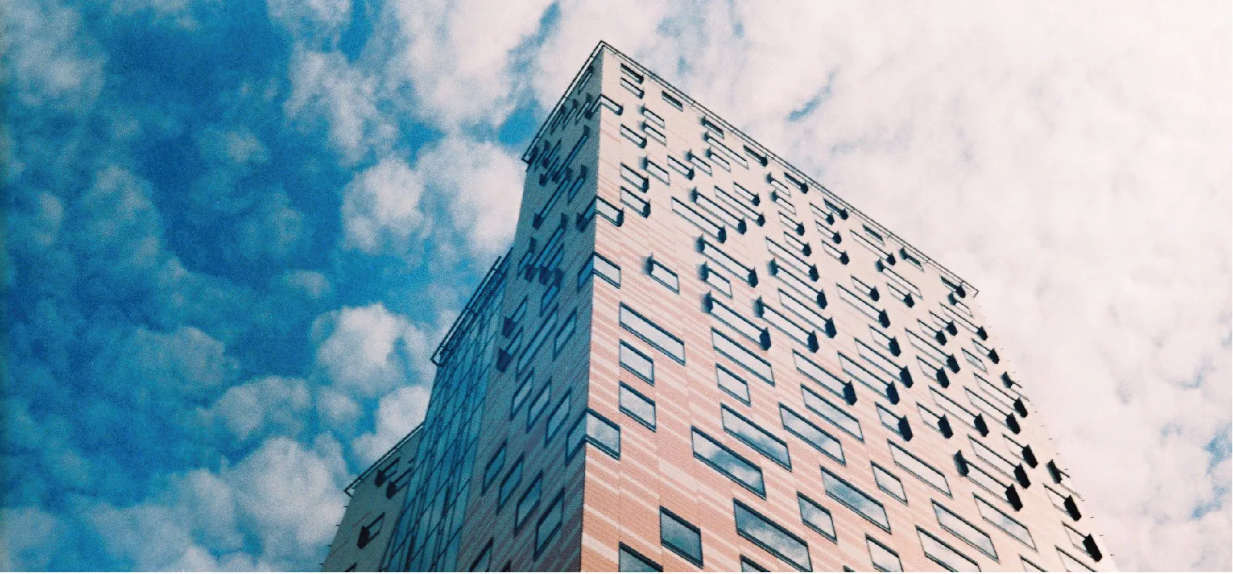 Photo of tall building with a cloudy background.