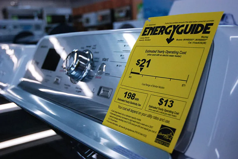 A close-up of an energy guide card on an appliance shows consumers expected costs and savings provided by that appliance.