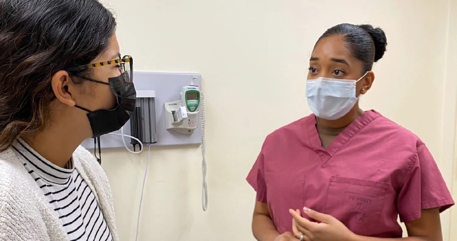 A nurse speaking with a patient.