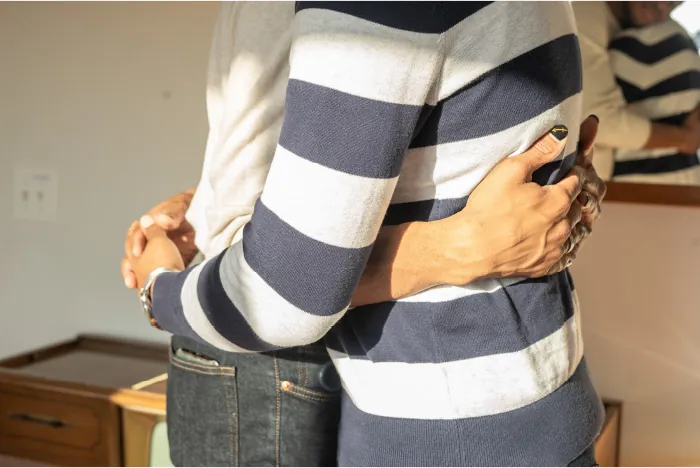 Photo of two individuals hugging.