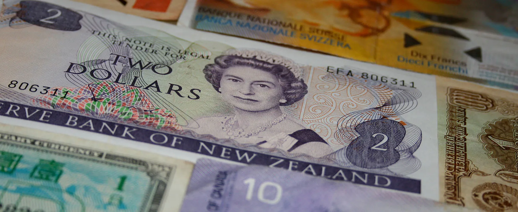 Collection of global currency notes and coins of different denominations.