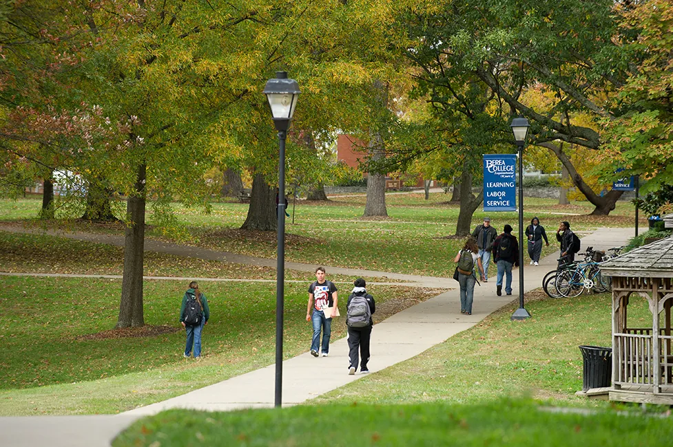 People are walking on a college campus.