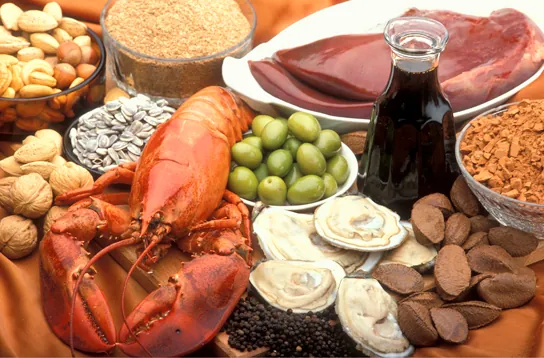 Photo shows a variety of foods, including lobster, clams, nuts and liver.