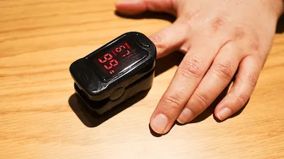 Pulse oximeter on patient’s finger.
