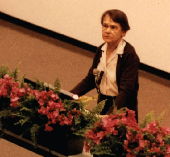 A photo shows Barbara McClintock giving her Nobel Lecture.