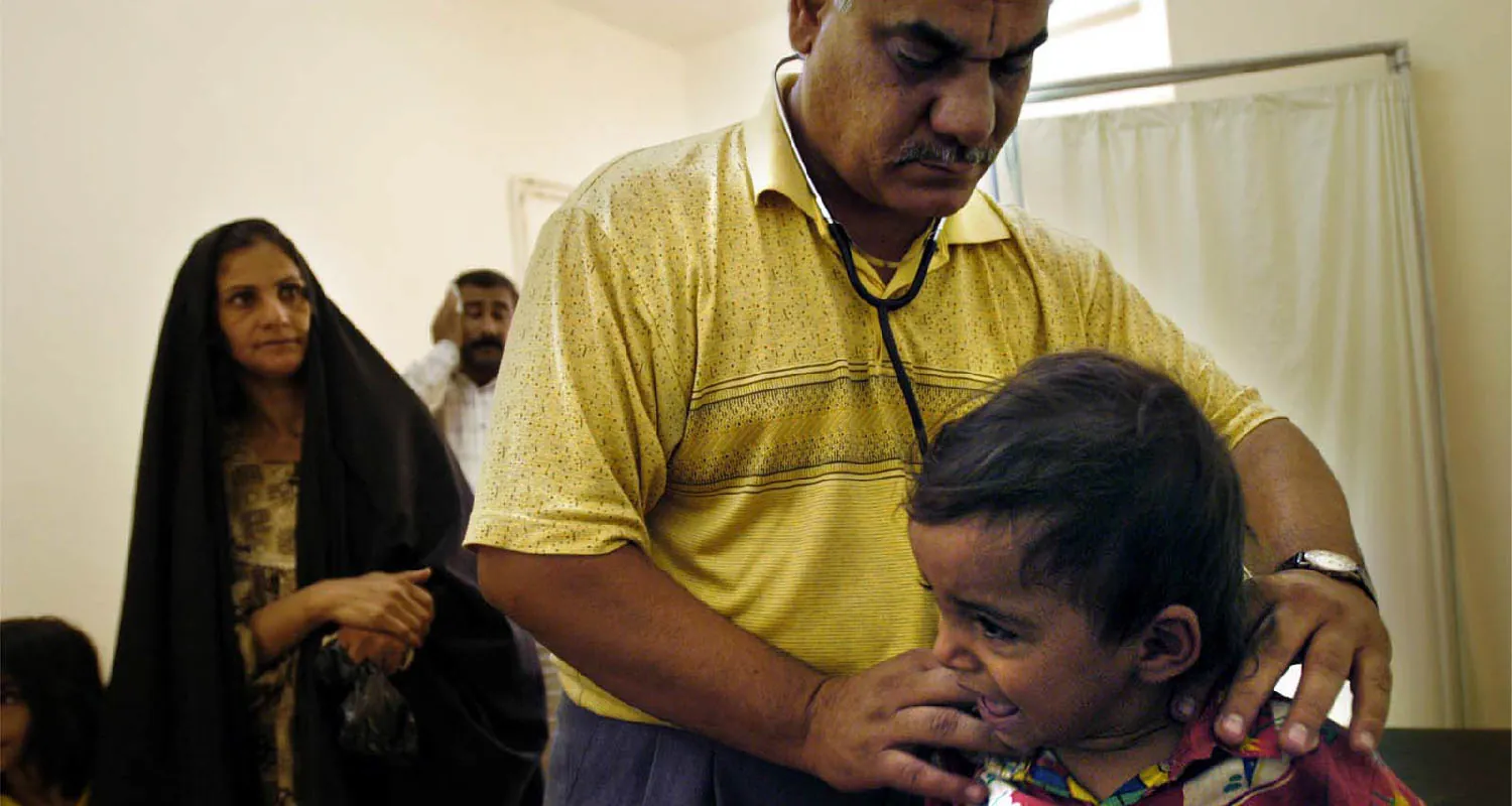 An Iraqi doctor examines a child.