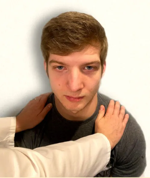 Image showing nurse’s hands on a simulated patient shoulders to assess the cranial nerve XI