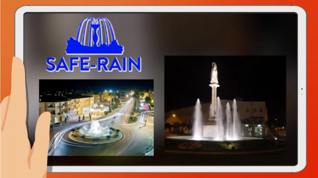 A tablet screen displays the SAFE-RAIN logo with a fountain icon, above two photos of illuminated fountains at night in city settings. A hand is seen on the left side of the tablet.