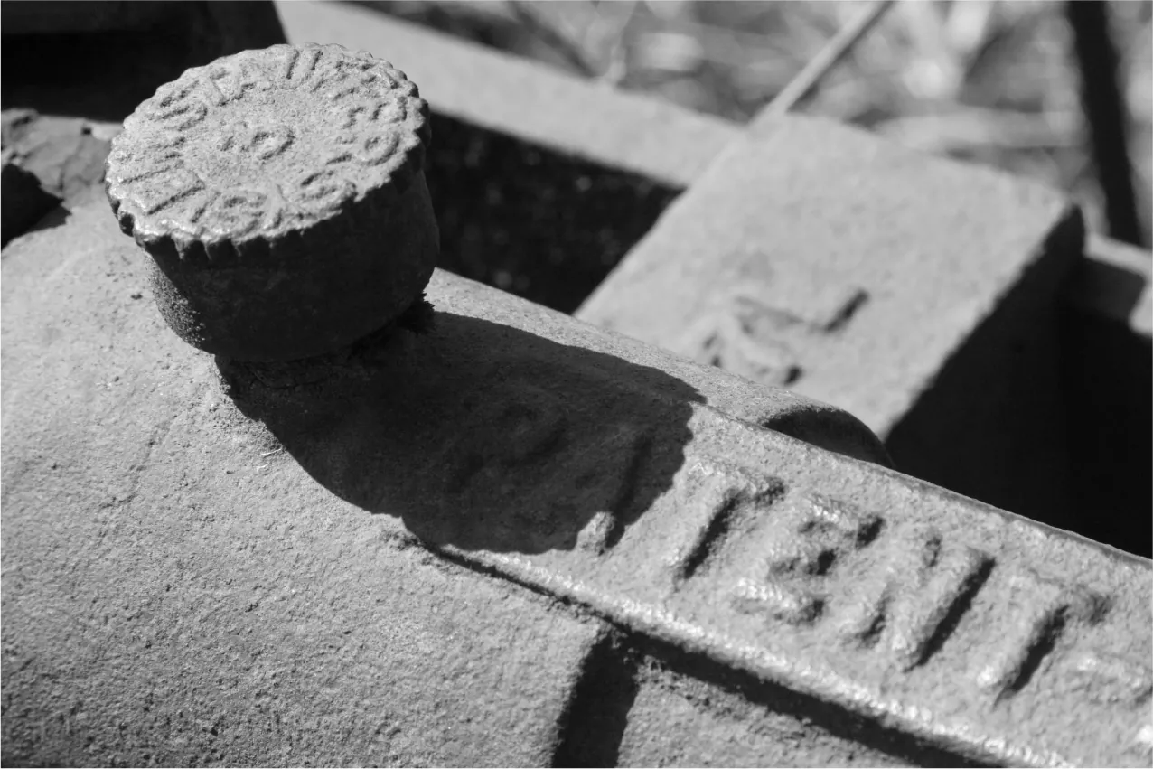 A closeup of a piece of machinery with the word "Patent" molded into it.