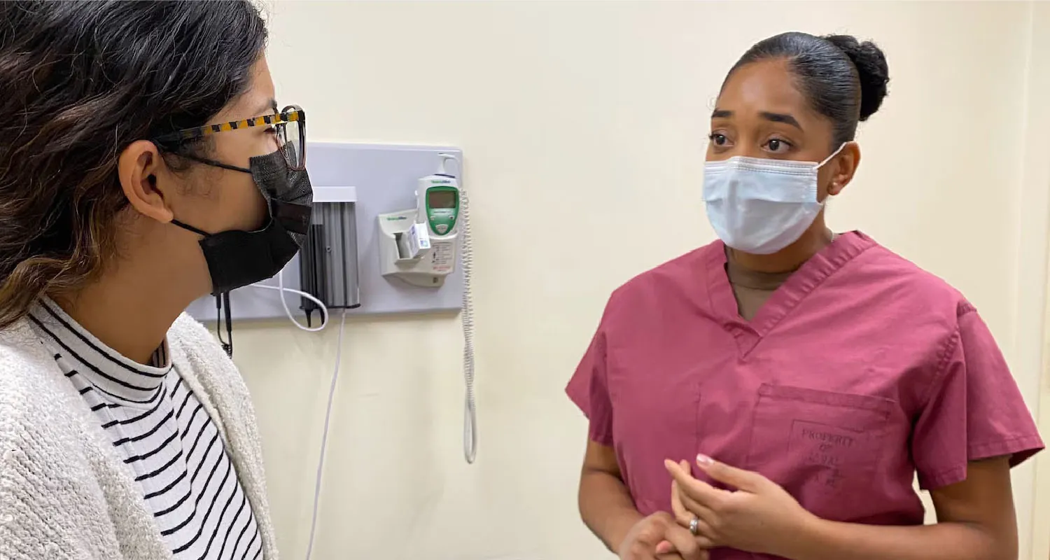 A photograph showing a hospital exam room with bed.