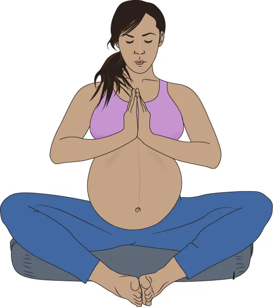 Image of pregnant person sitting cross legged on the ground.