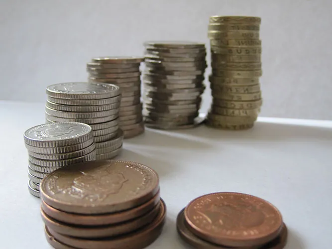Coins are placed in stacks ordered from smallest to largest.