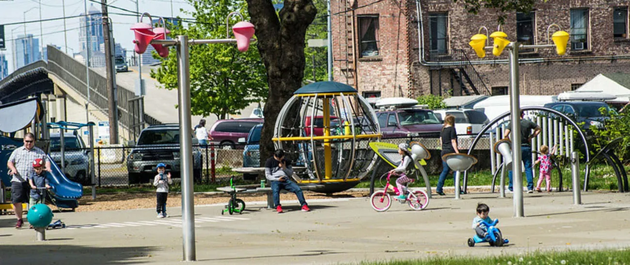 Image of children and adults playing in a park.
