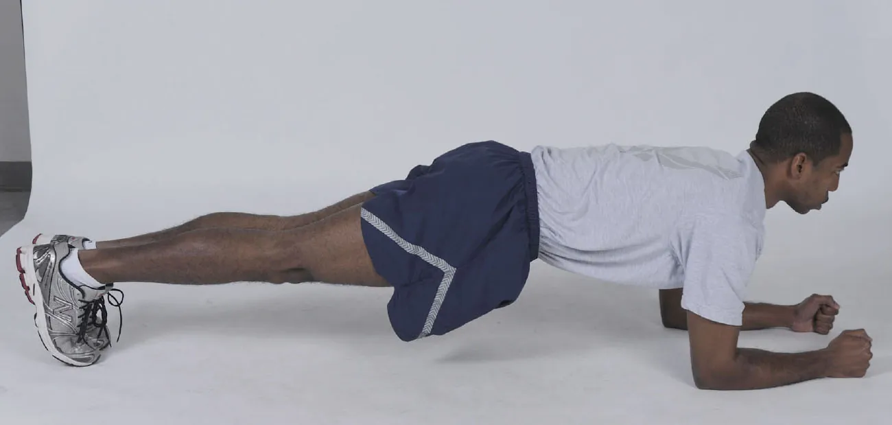 A person holds the plank position.
