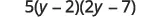 A mathematical expression displays 5 multiplied by the quantity (y minus 2), which is then multiplied by the quantity (2y minus 7), representing a factored quadratic expression.