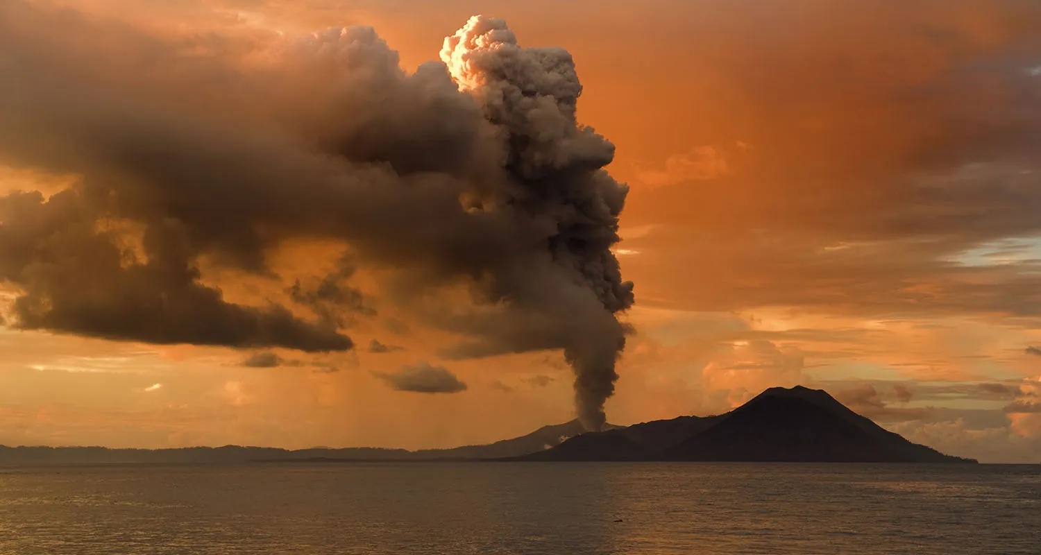 A volcanic eruption causing the release of gases.