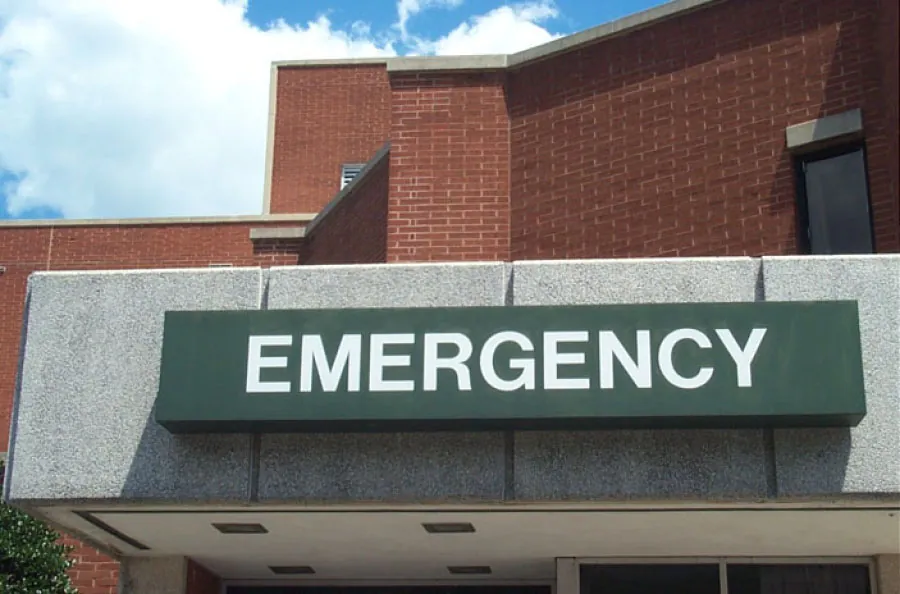 Photo showing the “EMERGENCY” sign outside a hospital emergency room.