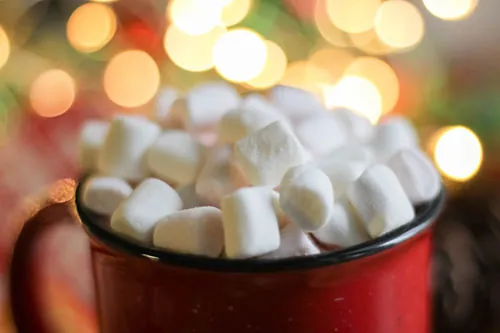 Photo of a red cup overflowing with marshmallows.