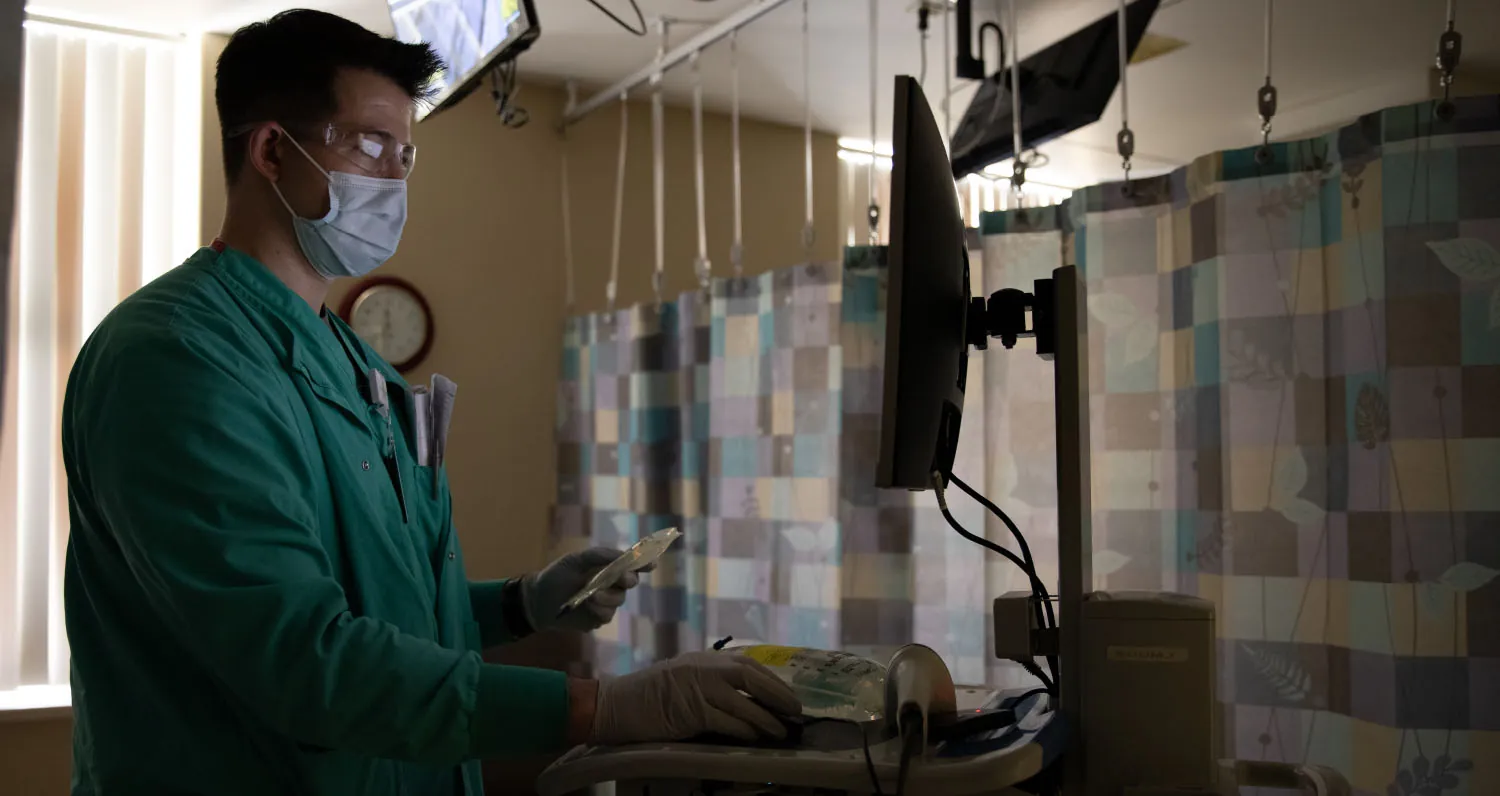 A color photograph shows a medical professional using a computer in a medical setting.