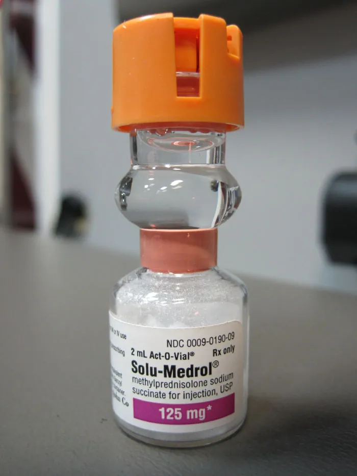 A photograph shows a dual-compartment vial system (Act-O-Vial) labeled Solu-Medrol.
