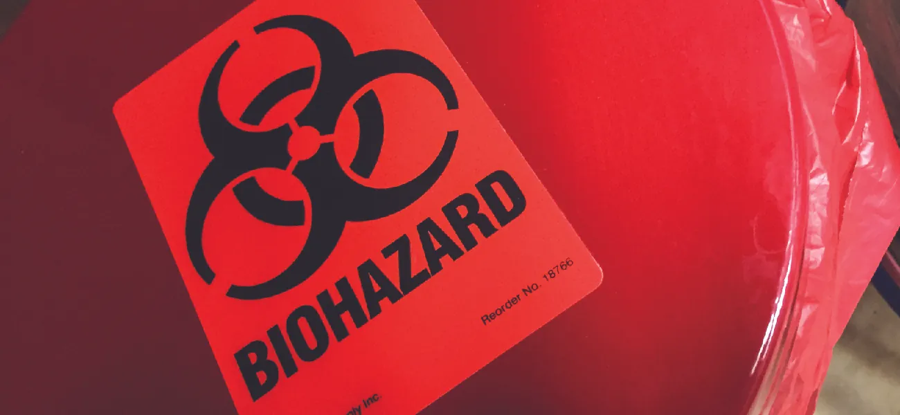 Red bag with a biohazard sticker on it.