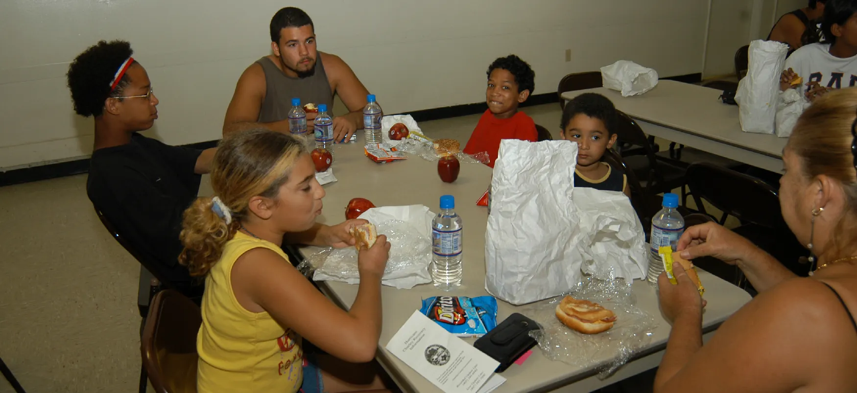 An evacuated&nbsp;Floridian&nbsp;family eats a makeshift meal at a shelter set up during Hurricane Charley in 2004.
