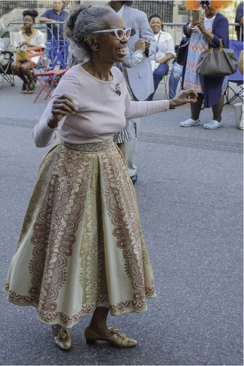 An older adult dances at an event.