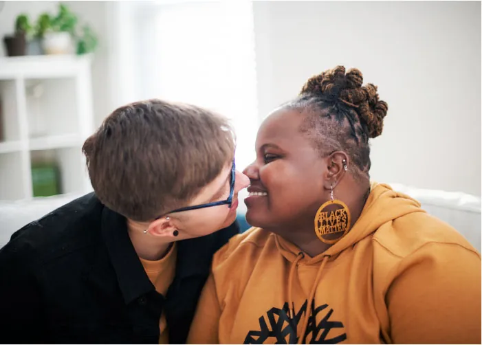 Photo of two individuals kissing each other.