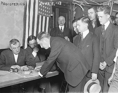 A photograph shows a group of young men registering for military conscription.